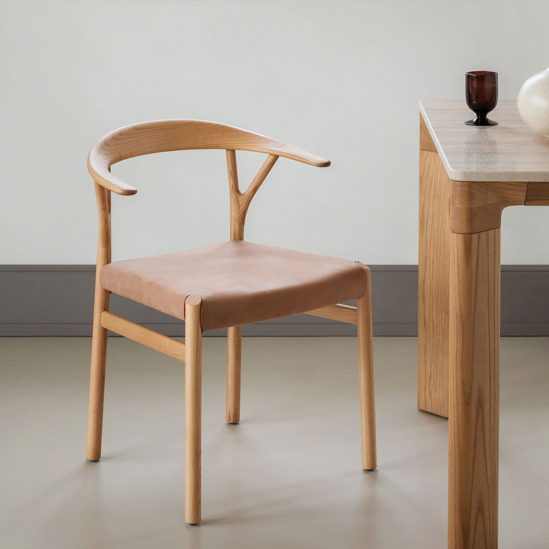 Natural wood chair with a soft pink fabric seat, featuring minimalistic design and smooth lines. Ideal for modern decor.
