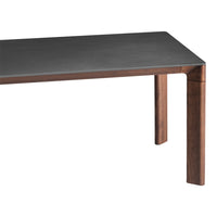 Modern rectangular table featuring a dark gray surface and rich walnut legs for a sleek, sophisticated look.