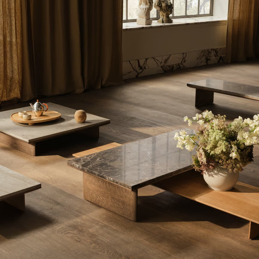 Stylish coffee tables showcasing gray stone and wood patterns in a warm, inviting indoor setting.
