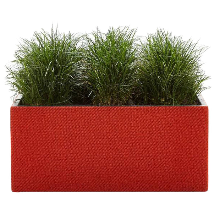 Red rectangular planter with green grass-like artificial plants for a vibrant, modern decor accent.