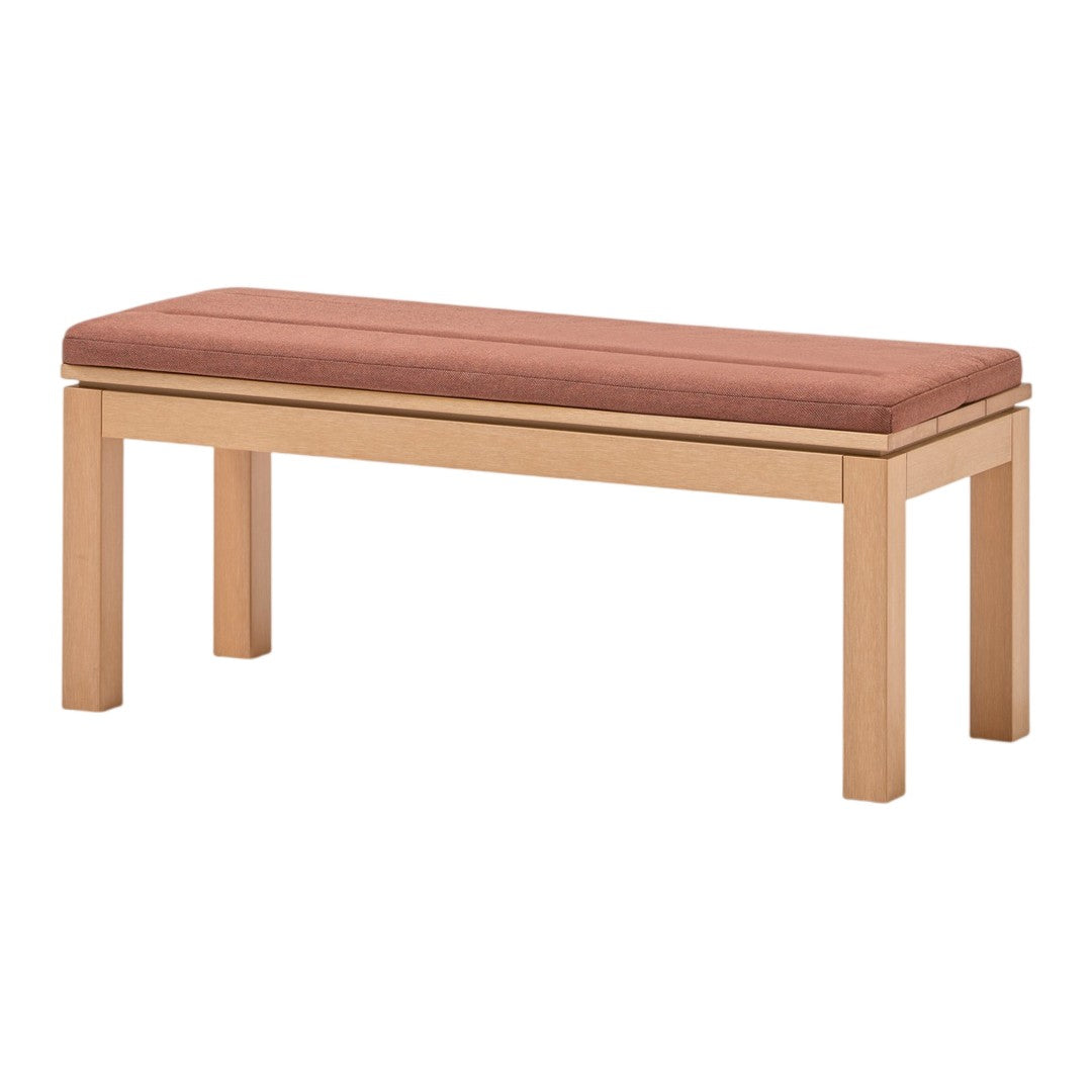 Wooden bench with light wood frame and soft, rust-colored upholstered seat. Simple, modern design.