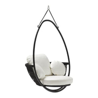 Black hanging egg chair with plush white cushions, featuring smooth curves and modern design. Perfect for stylish interiors.