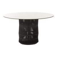 Modern round dining table with a sleek white top and textured black base, featuring vertical line patterns.