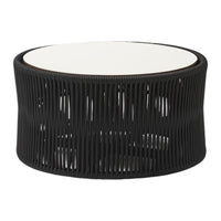 Black woven rattan table with a sleek white top and an open, airy design. Perfect for modern decor.