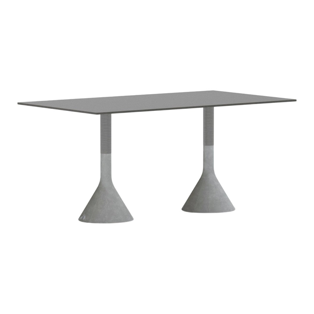 Modern gray dining table with sleek rectangular top and unique cone-shaped concrete bases. Minimalist design.
