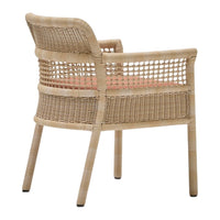 Natural woven rattan chair in beige with coral cushion, featuring a geometric open weave pattern on the backrest.