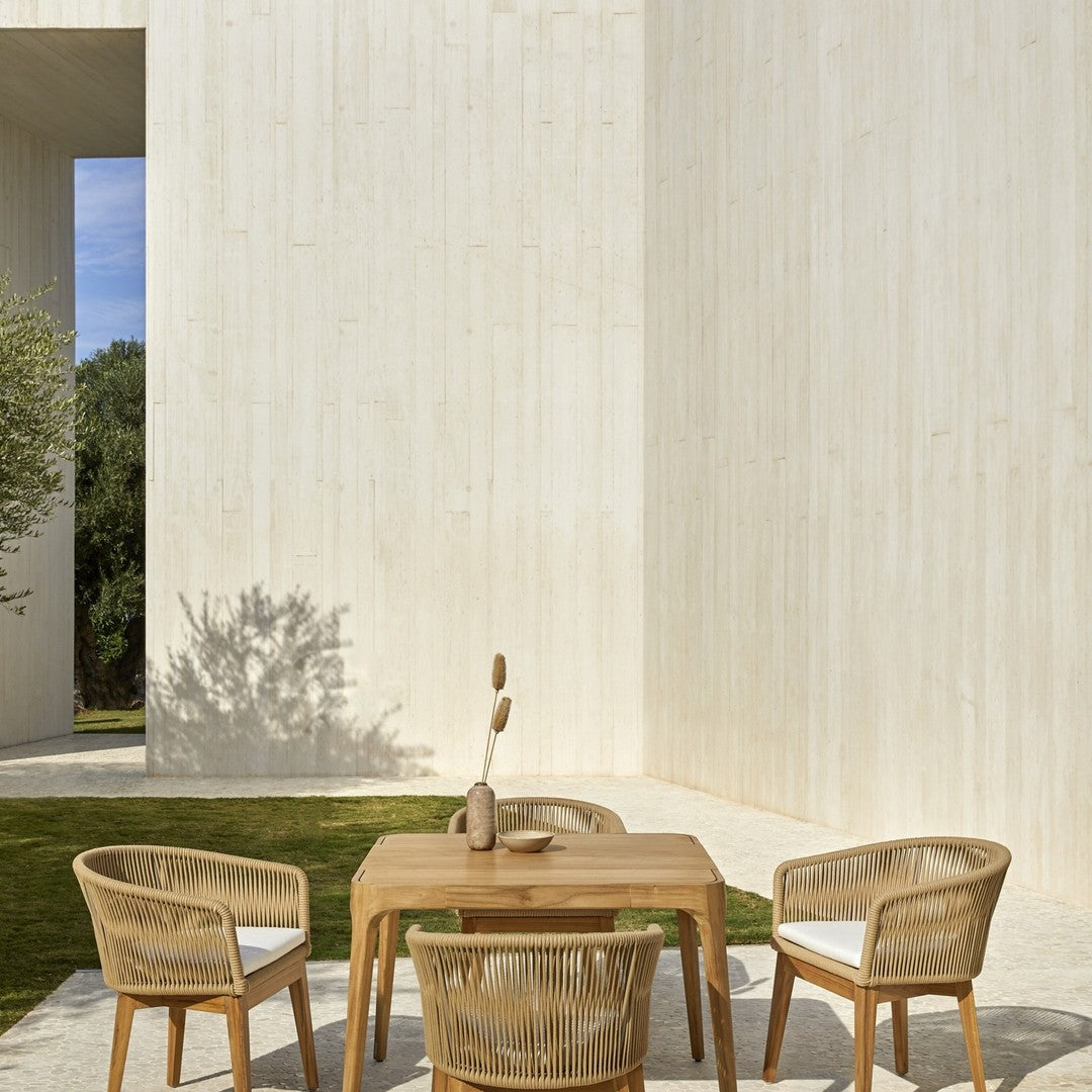 Light beige outdoor dining set with natural wood tones and woven patterns, set against a minimalist backdrop.