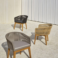 Three modern outdoor chairs in black, beige, and light brown with stylish woven patterns and wooden legs.