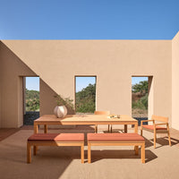 Natural wood tones with earthy beige walls and terracotta accents in a modern outdoor dining setup.