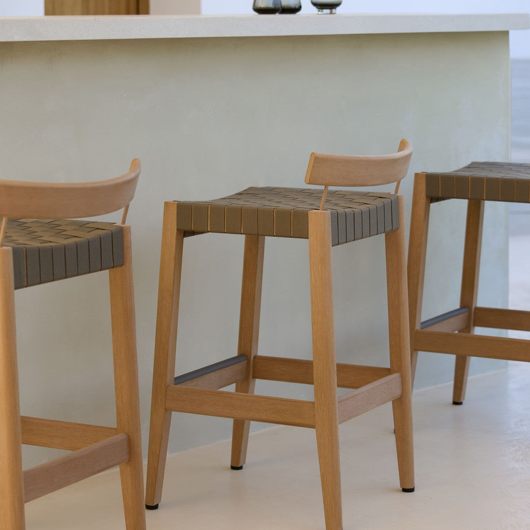Wooden bar stools with natural oak finish and textured gray seat patterns, ideal for modern interiors.