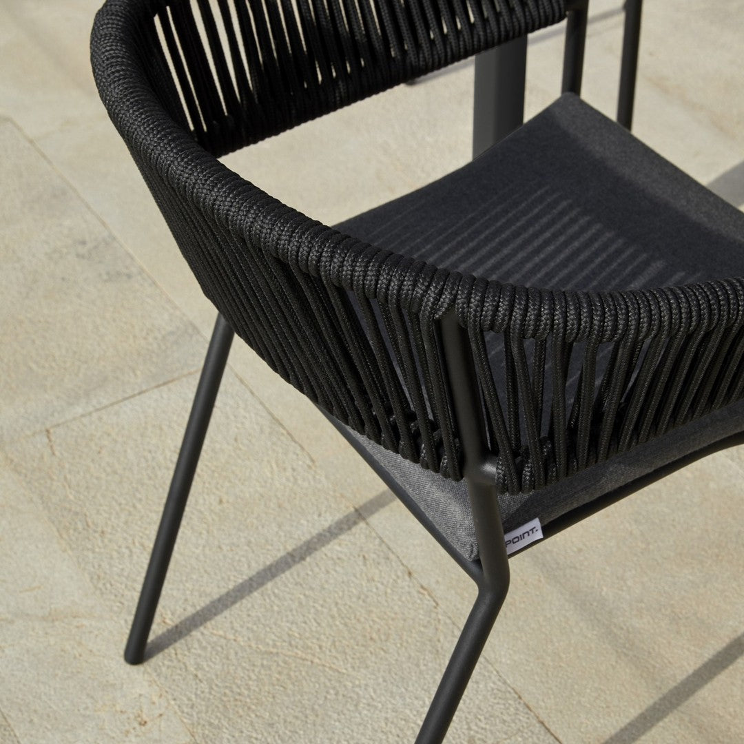 Black woven chair with a sleek, modern design and distinct vertical ribbed pattern. Ideal for stylish outdoor seating.
