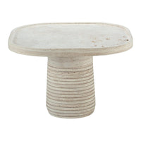 Round cream-colored side table with subtle textured lines and a smooth surface finish, featuring a minimalist design.