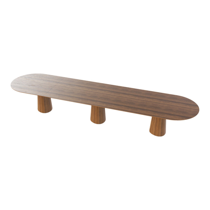 Long oval walnut coffee table with natural wood grain and three rounded pedestal legs. Elegant and modern design.