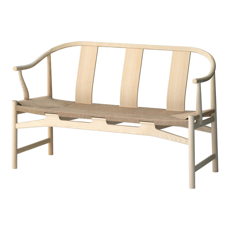 Light wood bench with a curved backrest and woven seat, featuring natural tones and a minimalist design.