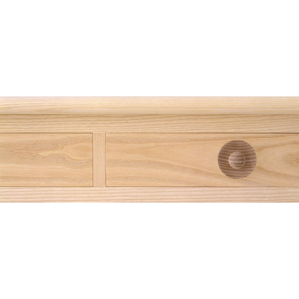Light natural wood drawer front with smooth grain and circular wood pattern accent.