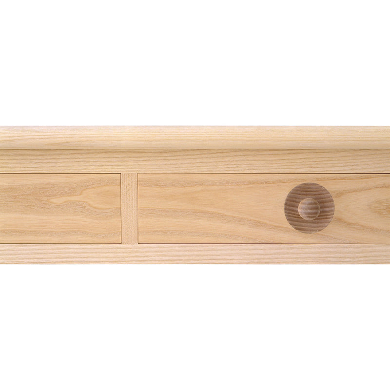 Light natural wood drawer front with smooth grain and circular wood pattern accent.
