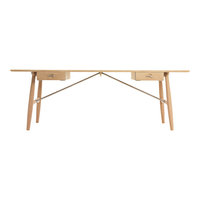 Light wood desk with a smooth, natural finish and minimalist design, featuring clean lines and subtle drawer accents.