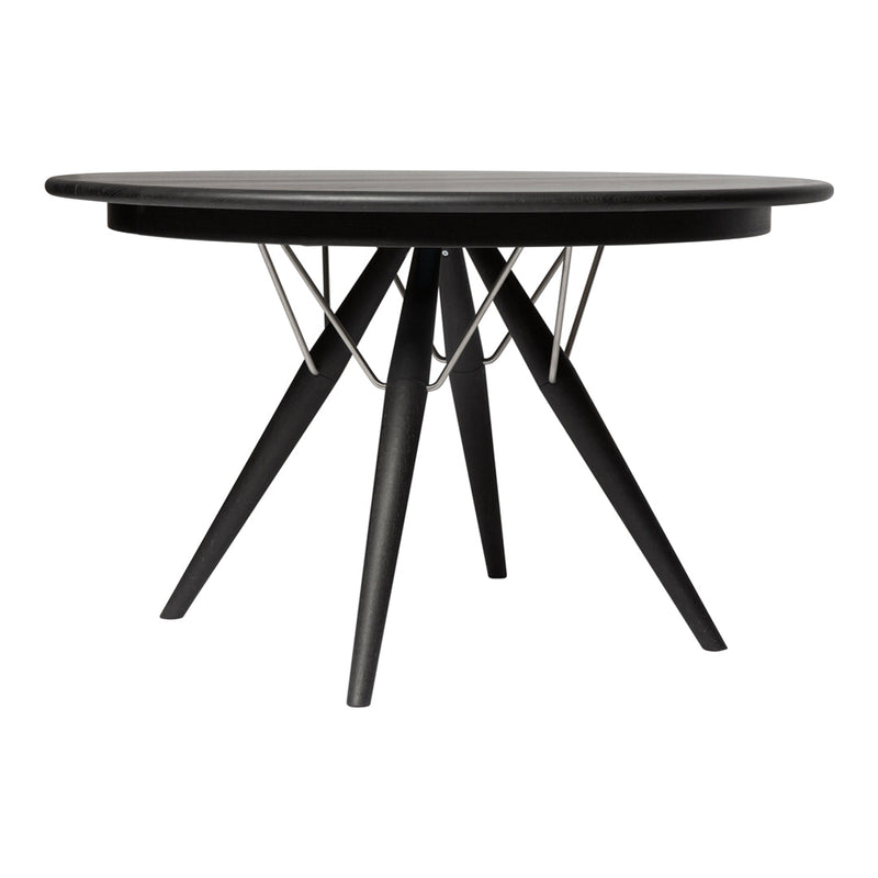 Modern round table with a sleek black top, featuring a unique geometric base and minimalist design. Perfect for any decor.