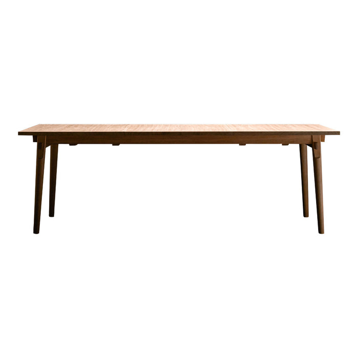Natural wooden dining table with a smooth light brown finish and simple, clean lines. Perfect for modern decor.