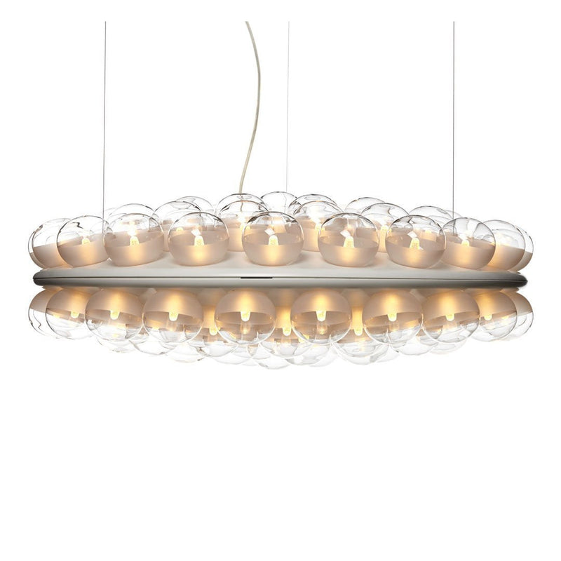 Modern pendant light with clear glass globes and a warm gold base, creating a sleek and elegant design.