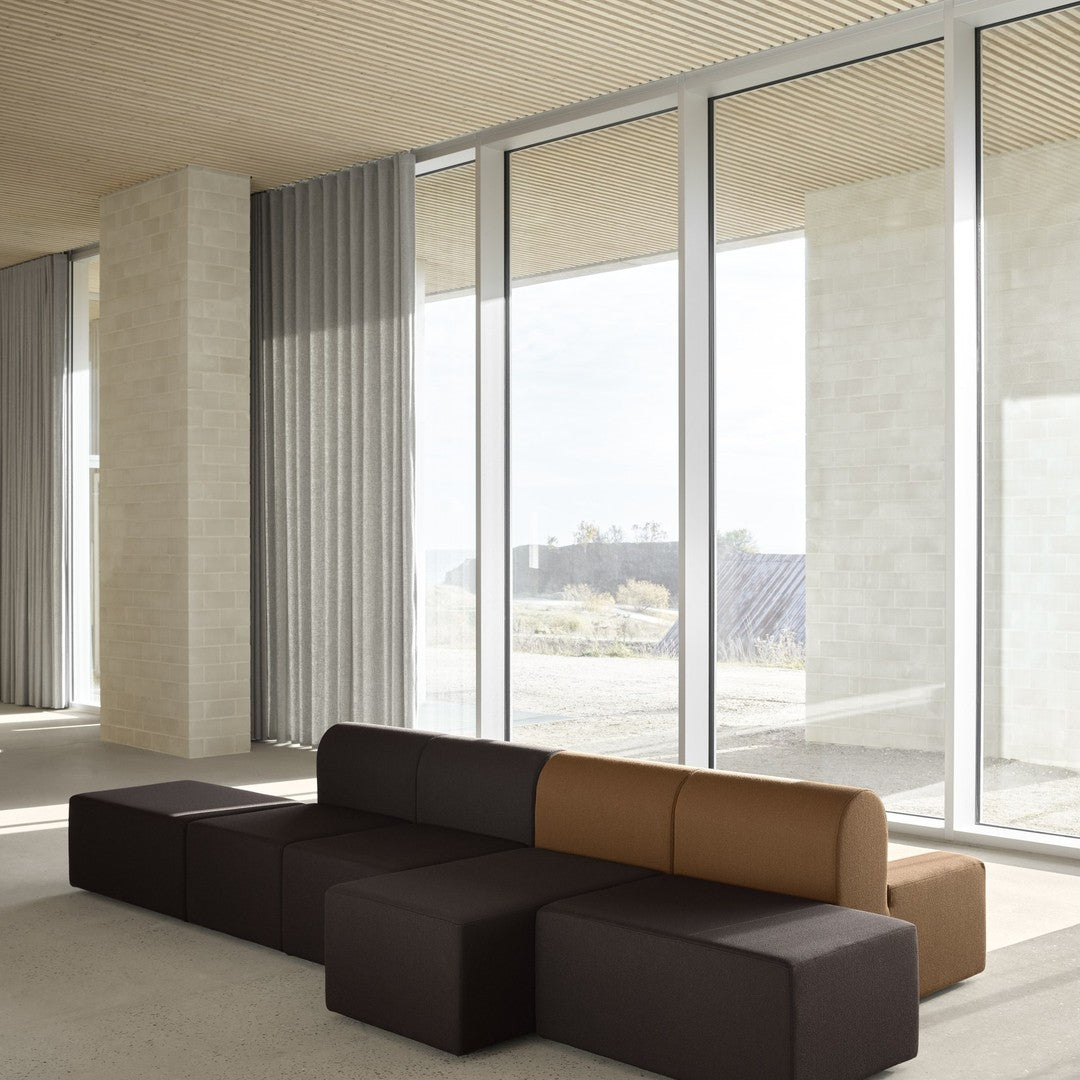 Modern sofa in warm brown and deep chocolate tones, featuring a sleek, geometric design.