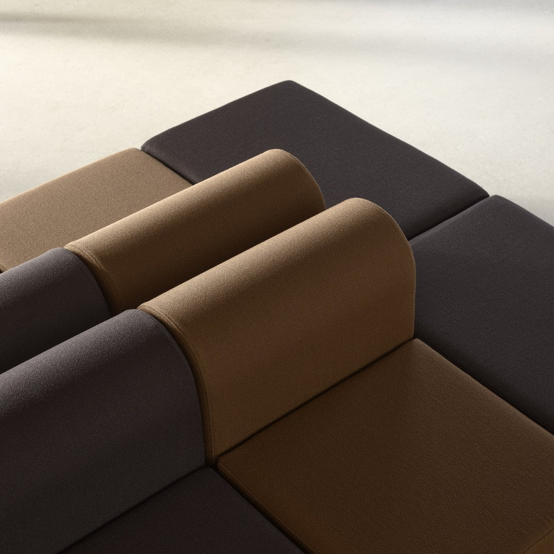 Modern modular sofa with dark brown and tan cushions, featuring a sleek geometric pattern.