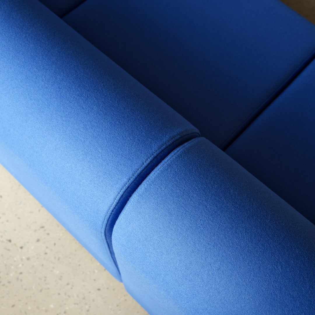 Close-up of vibrant blue upholstery with smooth, seamless design. Ideal for modern interior decor.