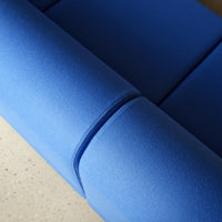 Close-up of vibrant blue upholstery with smooth, seamless design. Ideal for modern interior decor.