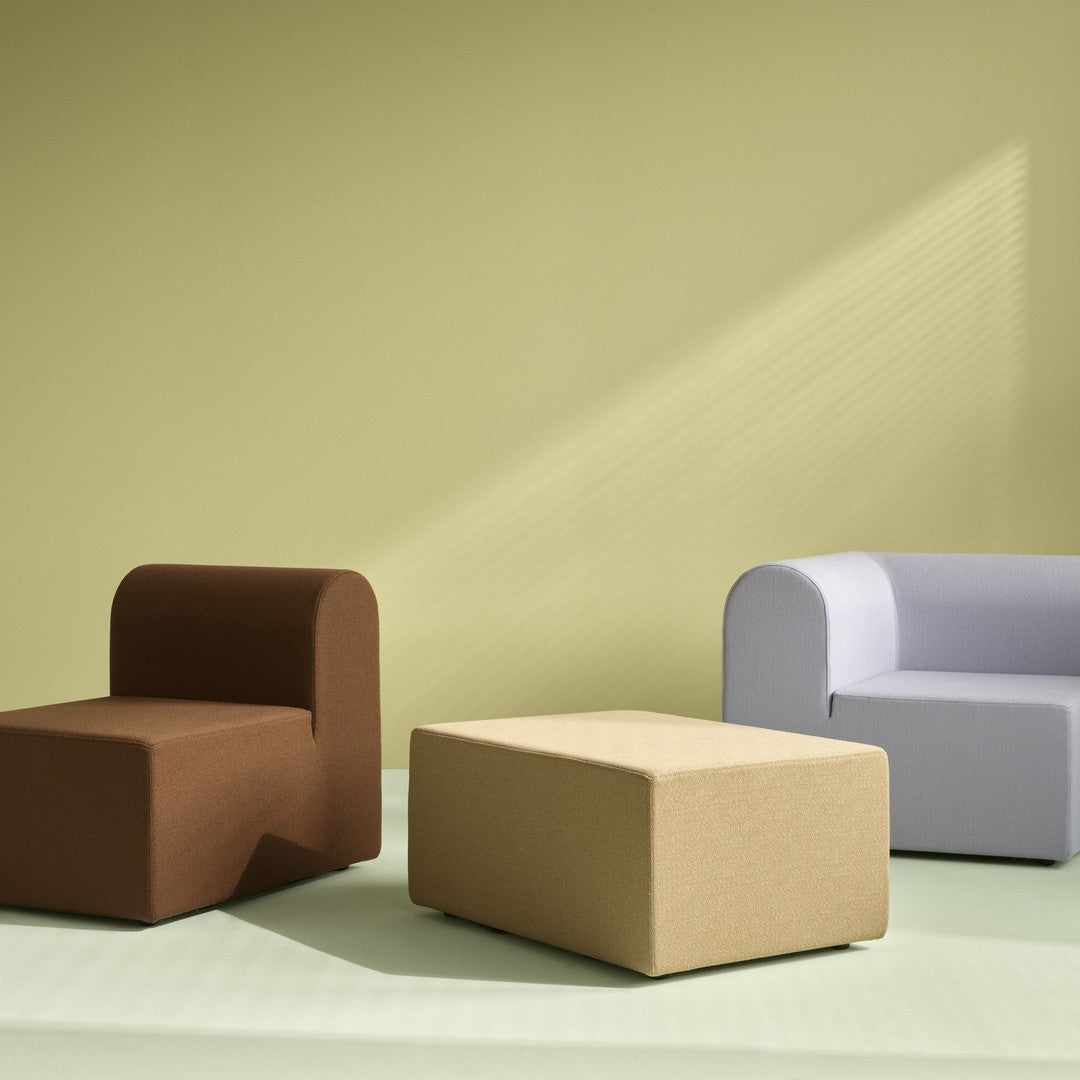 Modern furniture set featuring brown, beige, and light purple pieces against a soft green backdrop.