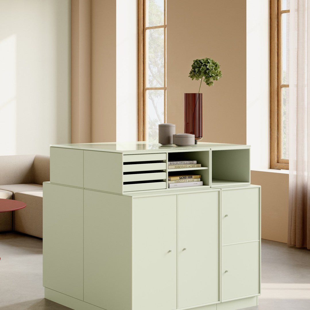 Light green modern storage cabinet with minimalist design, featuring smooth surfaces and subtle patterns.