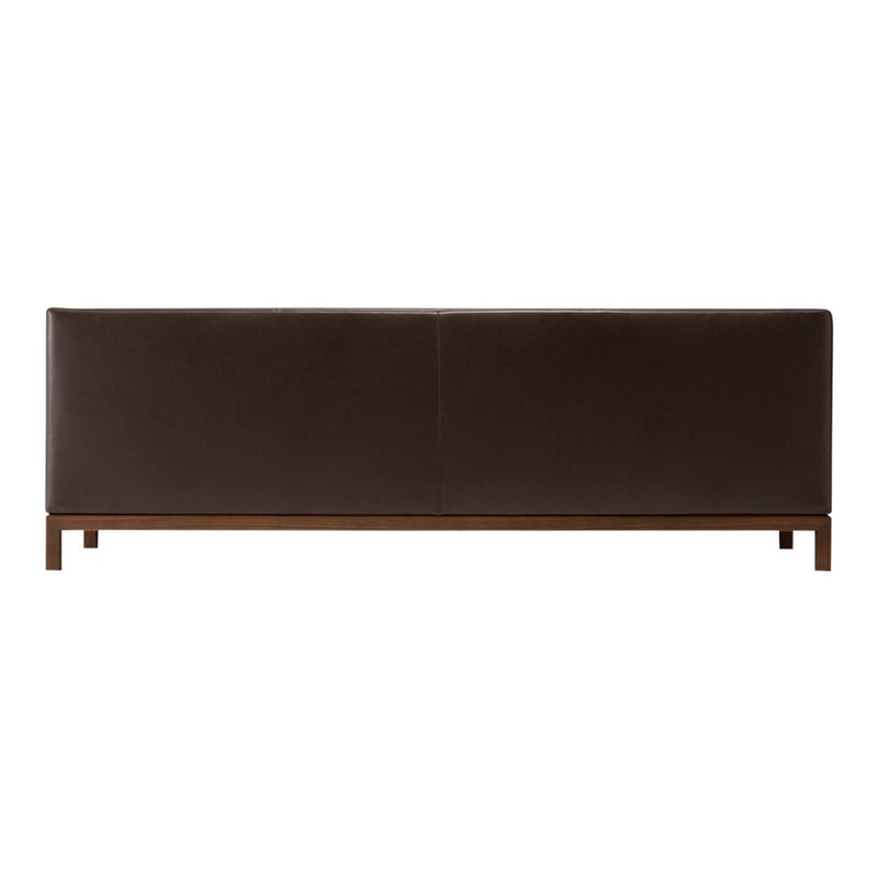 Brown leather bench with a smooth surface and sleek wood base. Minimalist design complements various decor styles.