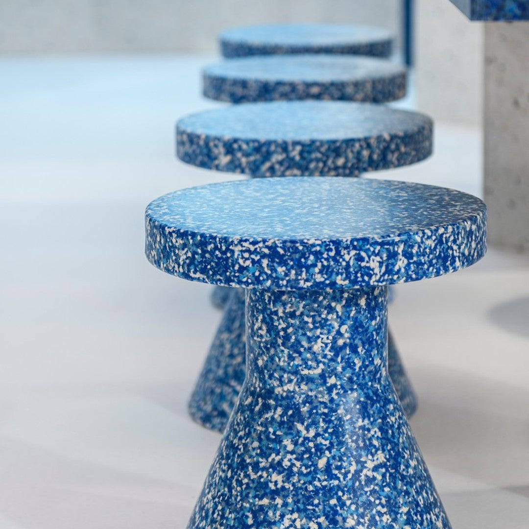 Blue patterned stools with a textured, speckled finish, showcasing a modern design aesthetic.