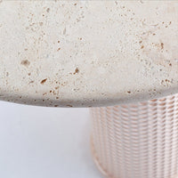 Light beige textured stone top with subtle speckles, paired with a soft pink woven base pattern.