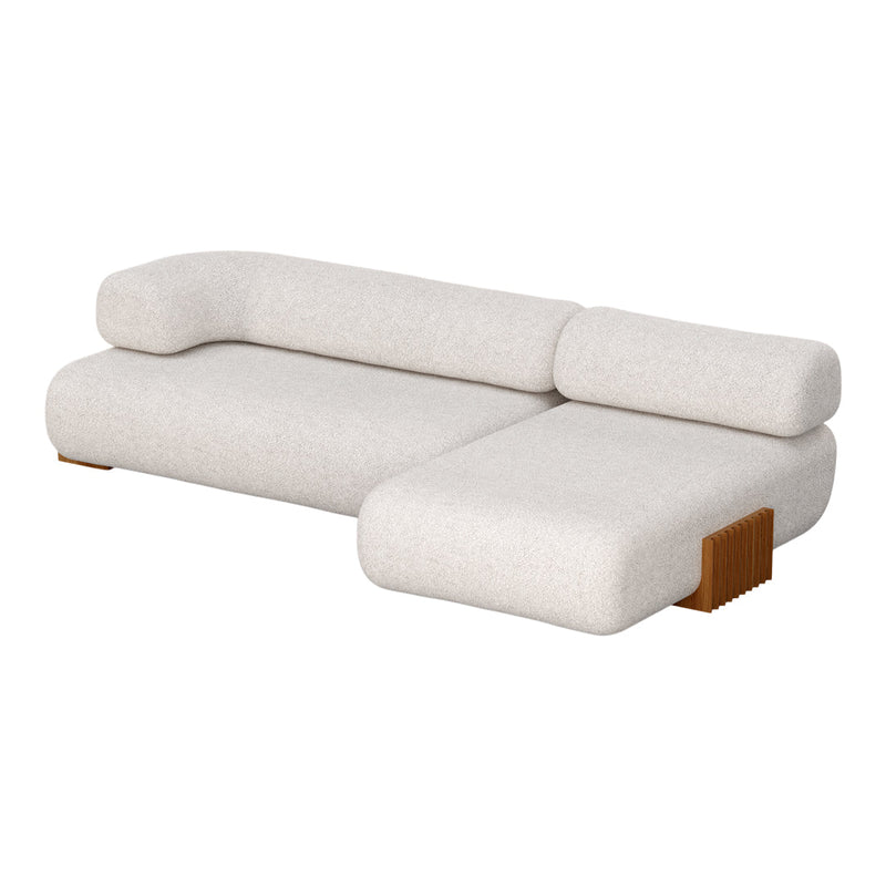Light beige sofa with a soft, textured fabric and minimalist design, featuring rounded edges and a wooden accent.