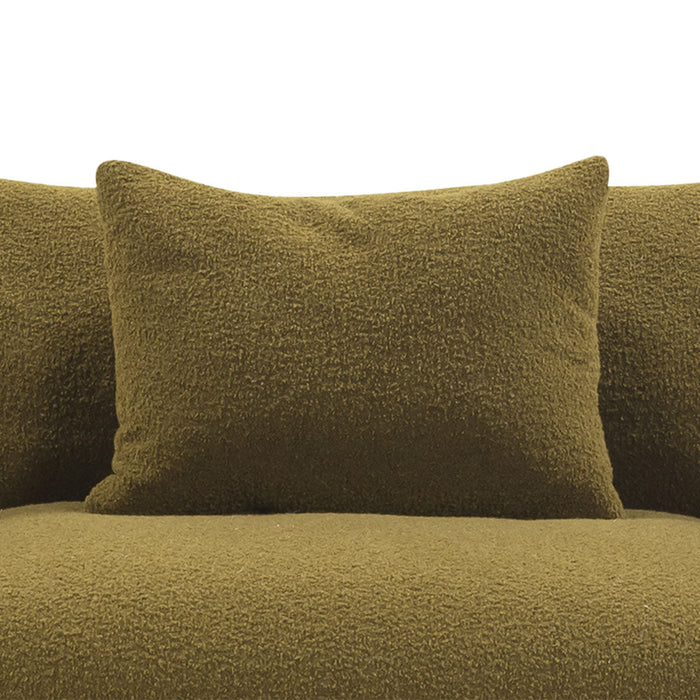 Textured olive green pillows on a plush olive green couch, enhancing modern decor with a cohesive color scheme.