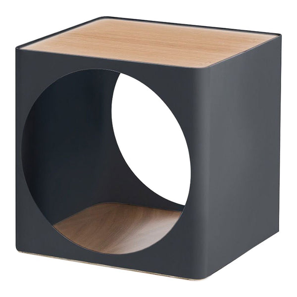Modern black cube table with circular cutout, featuring a natural wood top and base for a sleek, minimalist design.