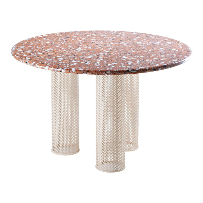 Round table with a speckled orange and white patterned top, featuring beige mesh legs for a modern aesthetic.