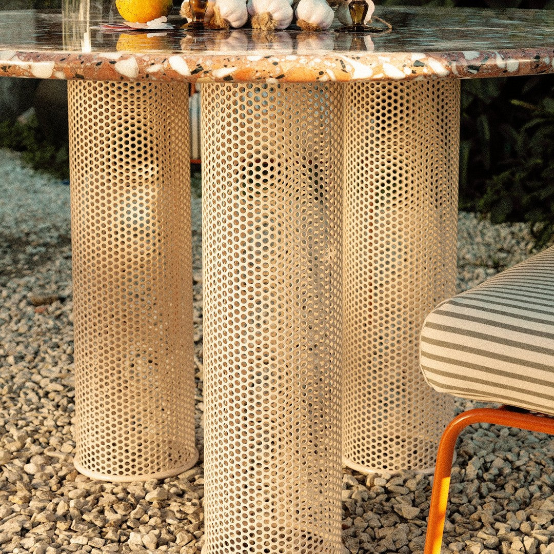 "Textured beige table legs with honeycomb pattern and a colorful marbled tabletop featuring earthy tones."