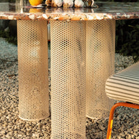 "Textured beige table legs with honeycomb pattern and a colorful marbled tabletop featuring earthy tones."