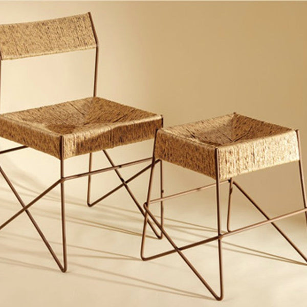 "Natural woven rattan chairs with brown metal frames, featuring a textured pattern and minimalist design."