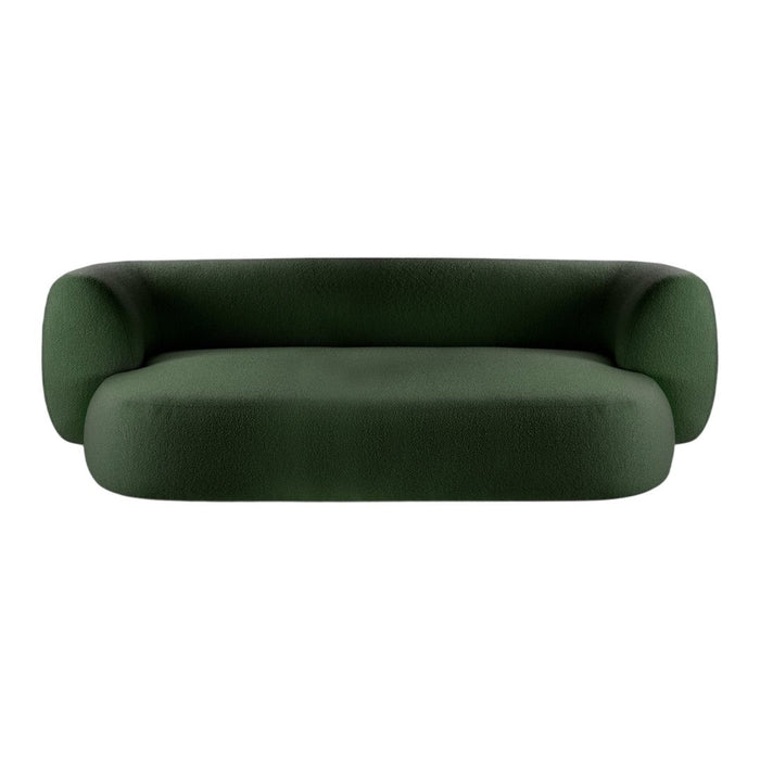 Green velvet sofa with a modern, minimalist design and soft, rounded shapes. Perfect for contemporary interiors.
