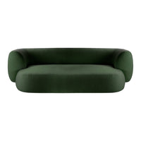 Bold green sofa with a smooth, minimalist design and rounded edges, perfect for modern interior decor.