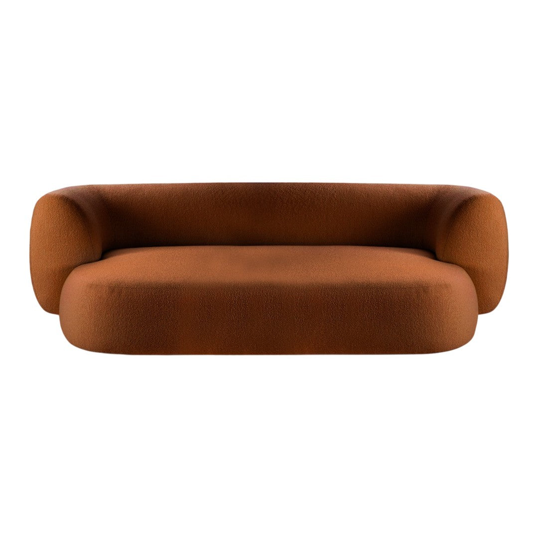 Rust-colored modern sofa with a sleek, minimalist design and soft, curved shapes. Ideal for contemporary interiors.