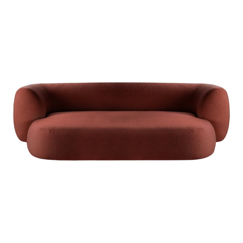 Rust-colored upholstered sofa with a smooth, rounded design and modern minimalist shape.