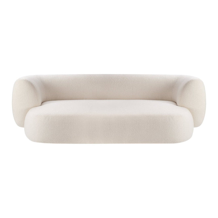 Curved cream-colored sofa with a smooth, minimalist design and plush upholstery, perfect for modern interiors.