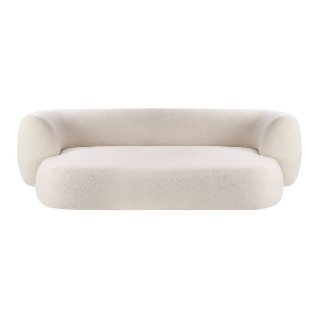 Light beige curved sofa with smooth, minimalistic design and a soft texture, perfect for modern interiors.