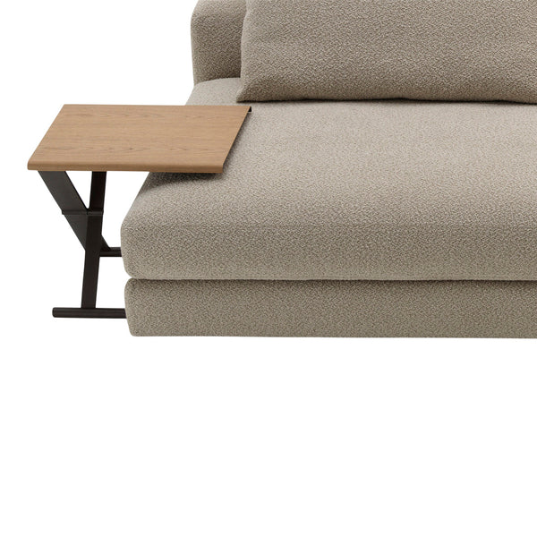 Soft beige plush couch with a wooden side table, featuring a smooth surface and minimalistic design.