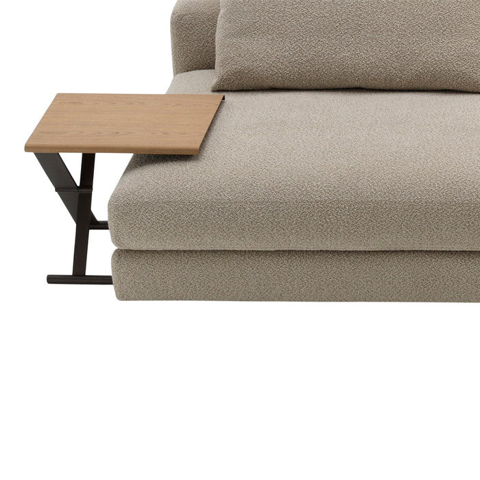 Soft beige plush couch with a wooden side table, featuring a smooth surface and minimalistic design.