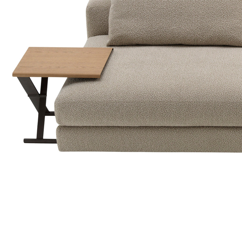 Soft beige plush couch with a wooden side table, featuring a smooth surface and minimalistic design.