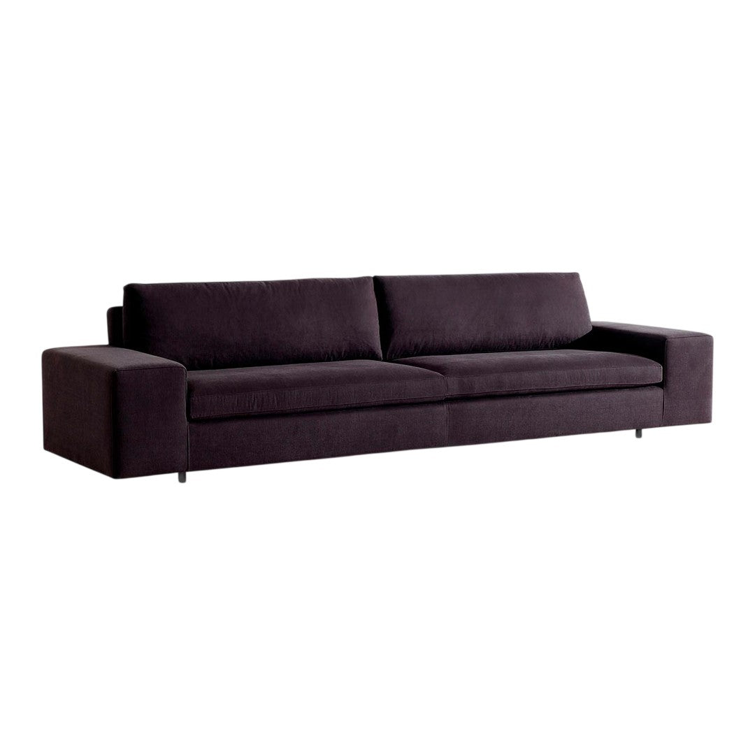 Modern dark purple sofa with a sleek, minimalist design and smooth fabric texture. Perfect for contemporary living spaces.